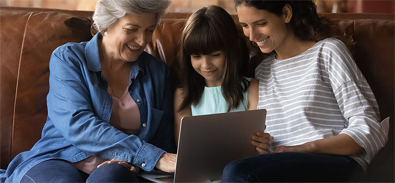Family gathered around a laptop